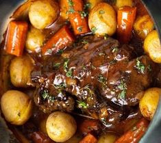 a pot roast with carrots, potatoes and gravy