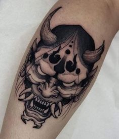 a black and white tattoo on the arm of a person with a skull head in it