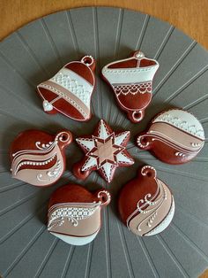 decorated cookies are arranged in the shape of christmas hats and sleighs on a platter