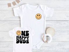 One Happy Dude Baby Bodysuit, Smiley Face First Birthday, First Birthday Outfit, Baby Birthday Outfit, First Birthday Shirt, Baby Bodysuit 💗  Welcome to The WildflowerbyMiley Etsy Shop!  This listing is for the bodysuit, sweatshirt or t-shirt only. All other items that are shown in our photos such as shoes, hats, beanies, blankets etc. are for photo staging purposes and are NOT INCLUDED in the sale. DESCRIPTION:  This baby and children's unisex essential fits like a well-loved favorite. Super soft t-shirts, sweatshirts and baby bodysuits for your little lads and gals meant to showcase their big personalities. Its Excellent quality and vibrant print makes one fall in love with it over and over again.  This adorable piece is the perfect lightweight layer for casual wearing.  This product is Playful Short Sleeve Bodysuit For Birthday, Playful Unisex Onesie For Birthday, Cute Unisex Bodysuit For Birthday, White Playful Onesie For Birthday, Playful White Onesie For Birthday, Smiley Face First Birthday, Baby Birthday Outfit, One Happy Dude, First Birthday Shirt