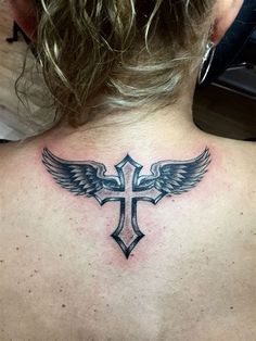 a woman with a cross and wings tattoo on her back