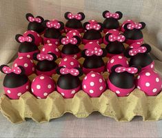 minnie mouse cupcakes in pink and white polka dots on an egg carton