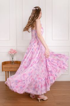 Step into the realm of love with our Aphrodite Dress. This gown features an ethereal one-shoulder silhouette with a voluminous full skirt, which invites you to twirl and dance with abandon. Adorned with cascading ruffles that froths like a soft cloud, its dramatic yet fanciful essence makes it the perfect choice for romantic endeavors. The delicate bow on the shoulder adds a touch of angelic charm, while the delicate pink floral print evokes a sense of blooming petals. Embrace your inner goddess