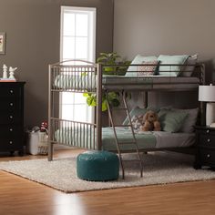 a metal bunk bed sitting on top of a hard wood floor next to a window