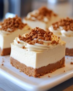 four pieces of cake on a white plate with some crumbs in the middle