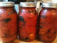 three jars filled with food sitting on top of a counter