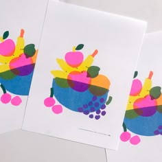 three cards with different designs on them sitting next to each other, one has fruit and the other has berries