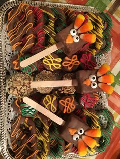 a platter filled with chocolate covered pretzels decorated like turkeys and birds