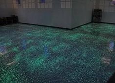 an empty room with green lights on the floor