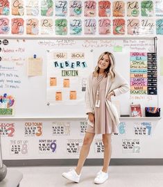 a woman standing in front of a bulletin board