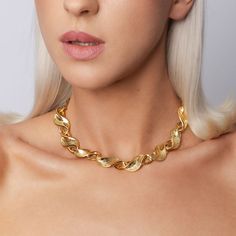 The Betsy Necklace is a bold and chunky choker-style piece featuring a twisted, original gold-plated chain with a glossy finish. Its design exudes confidence and makes a striking statement, perfect for adding a touch of vintage flair to any outfit. Avoid contact with make-up and chemical cleaning products Plating and lengths may vary as all products are handmade using vintage chains and charms