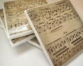 three coasters with sheet music on them