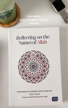 the book reflecting on the names of allah is next to a cup of coffee and a cell phone