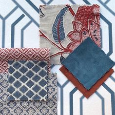 four different colored fabrics on a wall with geometric patterns and designs in blue, red, white and grey