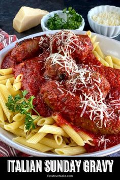 a plate of pasta with meatballs and parmesan cheese