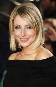 a woman with blonde hair and blue eyes smiles at the camera while standing in front of a crowd