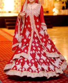 a woman in a red and white bridal gown