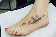 a woman's foot with a tattoo on it