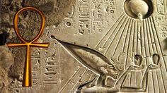 an egyptian symbol is shown on the side of a stone wall with other ancient symbols around it