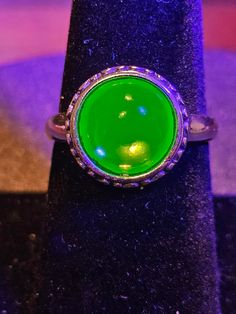 This gorgeous new sterling silver ring is adjustable in size and holds a vintage rounded top cabochon style stone in 10.5 mm round and has a brilliant glow under UV light. Check out my other Uranium glass jewelry. Don't see a ring in your size, just ask, I can often order one in in your size at a very minimal cost. I can also often get it in yellow or rose gold plated.  5% discount for local pickup. Adjustable Round Magical Jewelry, Adjustable Magical Round Rings, Adjustable Green Opal Ring, Green Luminous Round Jewelry, Mystical Round Cabochon Jewelry, Uranium Jewelry, Uranium Glass Collection, Uranium Glass Vintage Display, Luxury Iridescent Cabochon Rings