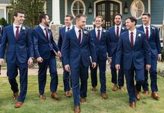 a group of men in suits and ties standing next to each other on the grass