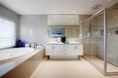 a bathroom with a tub, sink and shower in it's own area is shown