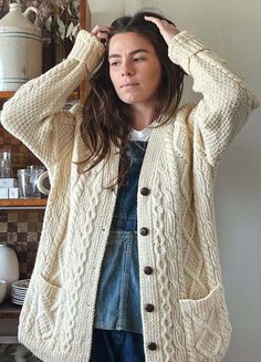 Chunky oversized wool fisherman cardigan with buttons    size: medium-extra large    flat measurements:    length 33“    pit to pit: 22“    shoulder: 18”    color: cream    fabrication: wool    madison is a medium    all items are preloved or vintage so might show signs of minor wear. anything major will be noted & photographed. Cozy Cream Sweater Coat With Buttons, Cream Knitted Outerwear For Fall, Cream Wool Chunky Knit Outerwear, Hand Knitted Cream Outerwear For Fall, Fall Cream Knitted Outerwear, Vintage Beige Chunky Knit Sweater, Cream Wool Cardigan With Chunky Knit, Cream Wool Chunky Knit Cardigan, Vintage Chunky Knit Cardigan For Fall