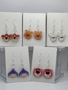 Celebrate the charm of your favorite character with these hand painted dangle earrings. The earring hooks  are made of .925 silver-plated they are  copper, and nickel-free and Hypo-allergenic. The earring backs are made of clear silicone, for comfort.  These characters are Tigger, Winnie, Piglet, Eeyore , and Strawberry Bear. Each is a hand painted acrylic design.  These character inspired earrings would make the perfect sweet gift for friends and family. They are versatile and ideal for any occasion, for everyday, and special events. They would be perfect for character enthusiasts, whether it's a birthday, holiday, or a thoughtful HAPPY to brighten they're day.  Every girl deserves earrings, as BEAUTIFUL as YOU are!! Count The Happies :) Cute Sterling Silver Earrings With Ear Wire, Handmade White Plastic Earrings, Hand Painted Polymer Clay Novelty Jewelry, Handmade Plastic Jewelry For Gifts, Hand Painted Novelty Resin Jewelry, Novelty Sterling Silver Hypoallergenic Earrings, Novelty Hand Painted Resin Jewelry, Novelty Hypoallergenic Sterling Silver Earrings, Hypoallergenic Novelty Sterling Silver Earrings