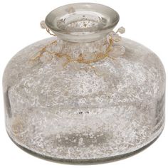 an old glass jar with gold trimmings on the top and bottom, sitting in front of a white background