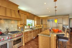 a kitchen with wooden cabinets and stainless steel appliances