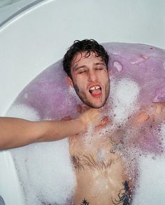 a man is taking a bath in the tub