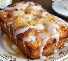 a close up of a pastry on a plate with syrup drizzled over it