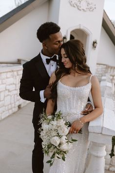 a man in a tuxedo standing next to a woman in a wedding dress