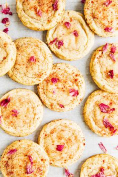 freshly baked cookies with cranberry toppings arranged on a baking sheet, top view