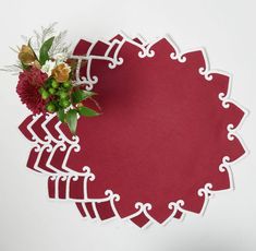 a paper doily with flowers on top of it