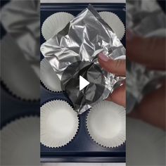 someone is holding some foil in their hand and it looks like they are making something