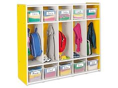 a yellow and white cubby with bins filled with clothes, books, and other items