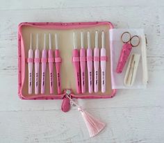 a pink case filled with different types of toothbrushes