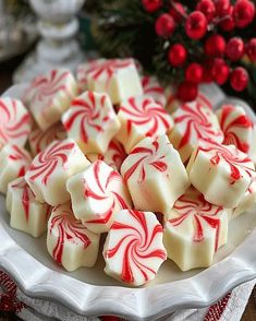 a white plate topped with red and white candy canes