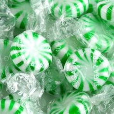 green and white striped candy balls in plastic wrappers