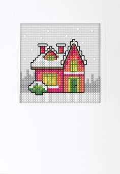 a cross - stitch picture of a house in the snow