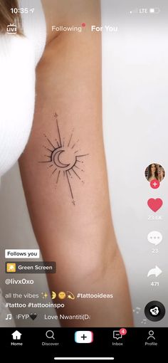 a woman's arm with a small sun tattoo on it