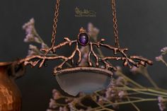 This is an one of a kind necklace inspired by nature. It features some fake tree branches embellished with an amethyst and a purple agate piece. Everything has been covered in copper and then varnished in order to protect the patina. This piece of jewelry would be perfect for a wicca or pagan person. The pendant measures approximately 11.5 cm (4.5 in) in width and 6 cm (2.4 in) in height. The necklace is adjustable between 40 cm (15.8 in) to 50 cm (19.7 in) in length. The colors of the product m Unique Purple Copper Necklace, Bohemian Amethyst Soldered Necklace, Unique Hand Forged Purple Necklaces, Bohemian Amethyst Necklace, Handmade Amethyst Necklace Nature-inspired, Fake Trees, Branch Necklace, Purple Agate, Necklace Jewelry