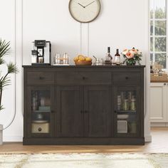 a kitchen area with a clock on the wall and various food items in front of it