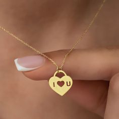 "This stunning 14K gold necklace is the perfect gift for your significant other.  The romantic padlock heart design symbolizes your love and commitment to each other, while the custom \"I Love You\" engraving adds a personal touch that will touch your soulmate's heart. Whether you're celebrating a special occasion or just want to show your love and appreciation, this necklace is an ideal gift that will make a lasting impression.  It comes in a beautiful gift box, making it a perfect present for Meaningful Heart Charm Necklaces For Valentine's Day, Meaningful Heart Charm Necklace For Valentine's Day, Personalized Charm Necklace For Valentine's Day, Engraved Charm Necklaces For Valentine's Day, Engraved Charm Necklace For Valentine's Day, Heart-shaped Charm Necklace For Mother's Day, Minimalist Charm Necklace For Valentine's Day, Engraved Charm Necklaces For Her On Valentine's Day, Valentine's Day Gift Heart Necklace With Charms