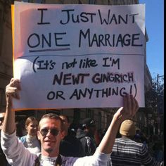 a man holding up a sign that says i just want one marriage it's not like i'm next church or anything