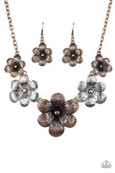 a necklace and earring set with flowers on the front, in bronze tone metal