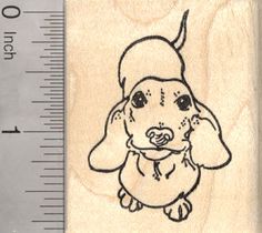 a rubber stamp with a drawing of a dog wearing a hat on it's head