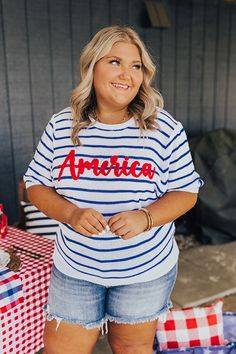 - Perfect for a relaxing backyard barbeque or a sunny day at the beach, this adorable sweater will keep you looking like America's sweetheart! Unlined material with a striped pattern - Cursive 'America' knit lettering across the front - A crew cut neckline - Short sleeves - A relaxed silhouette that ends in a ribbed hemline Measurements 1XL : Bust 44", Hip 40", Length 24.5", Sleeve Length 11", Waist 42". 2XL : Bust 48", Hip 44", Length 26", Sleeve Length 11.5", Waist 46". 3XL : Bust 50", Hip 46" Casual American Flag Print T-shirt, Relaxed Fit, Cursive S, Summer V-neck Tops With American Flag Print, Summer V-neck T-shirt With American Flag Print, American Flag Print V-neck Tops For Summer, Backyard Barbeque, Relaxing Backyard, Patriotic American Flag Print T-shirt In Relaxed Fit, Crew Cut