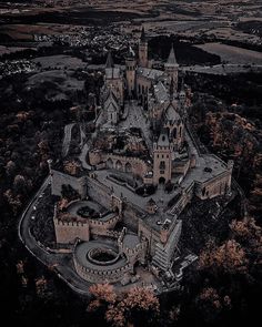 an aerial view of a castle surrounded by trees